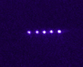 The magnificent five: Strontium ions in a vacuum chamber, trapped by electric fields and cooled by laser light to several millionths of a degree above absolute zero