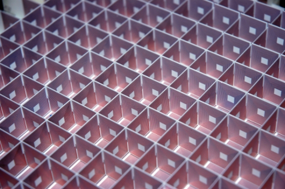 Each side of each constituent cube of the “superlens” is set with a long, spiraling copper coil